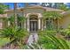 Beautiful front entrance showcasing a landscaped walkway leading to the double doors and architectural details at 5004 Waterkey Way, Tampa, FL 33647