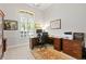 Well-lit home office with a large window, wooden desk, and ample storage space at 5004 Waterkey Way, Tampa, FL 33647