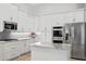 Updated kitchen featuring stainless steel appliances, granite counters, and white cabinetry at 5004 Waterkey Way, Tampa, FL 33647