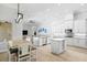 Bright open kitchen with white cabinetry, granite counters, and stainless steel appliances at 5004 Waterkey Way, Tampa, FL 33647