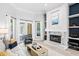 Bright living room with high ceilings, fireplace, and access to the outdoor patio area via French doors at 5004 Waterkey Way, Tampa, FL 33647