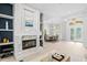 Open-concept living room with fireplace, natural light and clear views into the adjacent dining area at 5004 Waterkey Way, Tampa, FL 33647