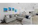 Stylish living room features a comfortable sectional sofa and views into the kitchen and other parts of the house at 5004 Waterkey Way, Tampa, FL 33647