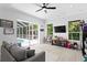 Bright living room with a view of the pool, featuring modern flooring and a ceiling fan at 5004 Waterkey Way, Tampa, FL 33647