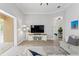 Open-concept living room with television, comfortable seating, view to foyer, and access to the screened-in pool at 5004 Waterkey Way, Tampa, FL 33647
