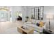 Bright living room featuring wood floors, a comfortable couch, and an adjacent home office behind glass doors at 5004 Waterkey Way, Tampa, FL 33647