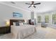 Large bedroom with a ceiling fan, dresser, and an exit to the pool area at 5004 Waterkey Way, Tampa, FL 33647