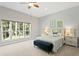 Spacious main bedroom featuring a large window with backyard views and stylish decor at 5004 Waterkey Way, Tampa, FL 33647