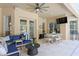 Outdoor patio featuring comfortable seating, a dining area, and access to the pool at 5004 Waterkey Way, Tampa, FL 33647