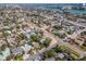Aerial shot highlighting neighborhood homes amidst lush trees and streets leading to homes with well-maintained yards at 515 77Th Ave, St Pete Beach, FL 33706