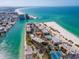 Aerial view of beachfront condos overlooking the ocean with a private beach, tennis courts, and turquoise water at 515 77Th Ave, St Pete Beach, FL 33706