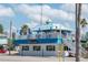 Charming two-story waterfront restaurant with outdoor seating under a vibrant blue awning at 515 77Th Ave, St Pete Beach, FL 33706