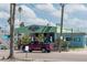 Unique waterfront restaurant with a red pick-up truck in front at 515 77Th Ave, St Pete Beach, FL 33706