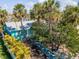 Charming light blue home with tropical landscaping, including palm trees and a quaint walkway leading to the front door at 515 77Th Ave, St Pete Beach, FL 33706