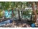 This yard is a quiet, shady space shaded by a few trees and featuring a brick walkway at 515 77Th Ave, St Pete Beach, FL 33706