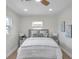 Bright bedroom featuring a ceiling fan, light hardwood floors, and neutral decor at 5833 Dartmouth N Ave, St Petersburg, FL 33710