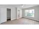 Bedroom with hard floors, sliding closet door, ensuite bathroom, and natural light at 5833 Dartmouth N Ave, St Petersburg, FL 33710