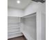 Walk-in closet with hardwood floors, shelves, hanging rod, and built in bench at 5833 Dartmouth N Ave, St Petersburg, FL 33710
