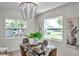 Bright dining room features a glass table and decorative chandelier at 5833 Dartmouth N Ave, St Petersburg, FL 33710