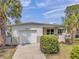 Charming single-story home with lush landscaping and a well-maintained lawn at 5833 Dartmouth N Ave, St Petersburg, FL 33710