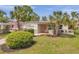 Charming single-story home with lush landscaping, a well-manicured lawn, and a welcoming front entrance at 5833 Dartmouth N Ave, St Petersburg, FL 33710