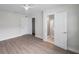 Spacious main bedroom features sleek wood floors, a ceiling fan, and access to an en-suite bathroom and large closet at 5833 Dartmouth N Ave, St Petersburg, FL 33710