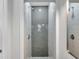Updated shower showcasing elegant gray herringbone tile, sleek fixtures, and contemporary design for a spa-like experience at 5833 Dartmouth N Ave, St Petersburg, FL 33710