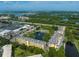 Aerial view of the community with lush landscaping, a tranquil lake, and community amenities at 5849 Park N St # 308, St Petersburg, FL 33709