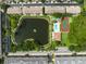 Top-down aerial view of a community pond, pool, and tennis court surrounded by townhomes at 5849 Park N St # 308, St Petersburg, FL 33709