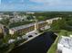 Aerial view of the community showcasing well-maintained buildings, lush landscaping, and a serene lake at 5849 Park N St # 308, St Petersburg, FL 33709