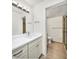 Bright white bathroom with glass enclosed shower, vanity and updated fixtures at 5849 Park N St # 308, St Petersburg, FL 33709