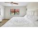Cozy bedroom with white bedding, fan and laminated floor at 5849 Park N St # 308, St Petersburg, FL 33709