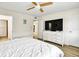 Bedroom showcasing laminated floor, adjacent bathroom, and wall-mounted television at 5849 Park N St # 308, St Petersburg, FL 33709