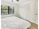 Bright bedroom with closet, laminated floor, fan and a scenic window view at 5849 Park N St # 308, St Petersburg, FL 33709