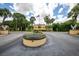 Scenic view of the community entrance featuring lush landscaping and clear signage at 5849 Park N St # 308, St Petersburg, FL 33709