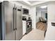 Modern kitchen showcasing stainless steel refrigerator, oven, and tile flooring at 5849 Park N St # 308, St Petersburg, FL 33709