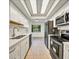 Galley kitchen with stainless steel appliances, white cabinetry, and recessed lighting at 5849 Park N St # 308, St Petersburg, FL 33709