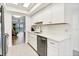 Bright kitchen featuring white cabinetry, stainless steel appliances, and tile flooring at 5849 Park N St # 308, St Petersburg, FL 33709