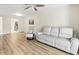 Spacious living room featuring new flooring, a sofa, and an armchair at 5849 Park N St # 308, St Petersburg, FL 33709