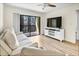 Comfortable living room with a ceiling fan, sliding doors, and a sofa at 5849 Park N St # 308, St Petersburg, FL 33709
