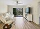 Bright living room with new floors, a ceiling fan, and a screened lanai at 5849 Park N St # 308, St Petersburg, FL 33709