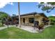 Outdoor patio with seating, a grill, colorful plants and meticulously manicured lawn at 5849 Park N St # 308, St Petersburg, FL 33709