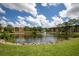 Exterior view of the property, highlighting a tranquil pond with fountain and surrounding lush landscaping at 5849 Park N St # 308, St Petersburg, FL 33709