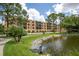 Beautiful exterior view of the property showcasing a tranquil pond and lush landscaping at 5849 Park N St # 308, St Petersburg, FL 33709