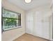 Bright room with large window, tiled floors, and built in storage cabinets at 5849 Park N St # 308, St Petersburg, FL 33709