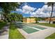 Image features community shuffleboard courts and clubhouse with palm trees and lush landscaping at 5849 Park N St # 308, St Petersburg, FL 33709