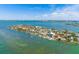 Stunning aerial view of a waterfront neighborhood with beautiful homes, private docks, and scenic bay views at 601 Boca Ciega Isle Dr, St Pete Beach, FL 33706
