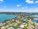 Picturesque aerial view capturing homes nestled along the waterfront with clear blue skies and scattered clouds at 601 Boca Ciega Isle Dr, St Pete Beach, FL 33706