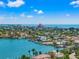 Scenic aerial view showcasing waterfront properties bordering a serene bay under a partly cloudy blue sky at 601 Boca Ciega Isle Dr, St Pete Beach, FL 33706