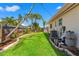Landscaped backyard featuring a well-manicured lawn, and bordered by a wood fence and mature trees at 601 Boca Ciega Isle Dr, St Pete Beach, FL 33706